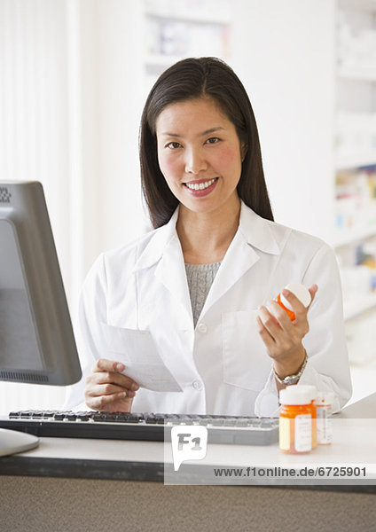 Pharmacist holding prescription medication