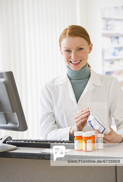 Pharmacist holding prescription medication