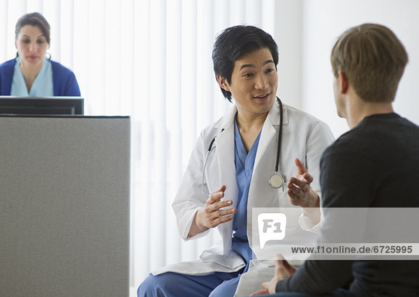 Doctor talking to patient in waiting room