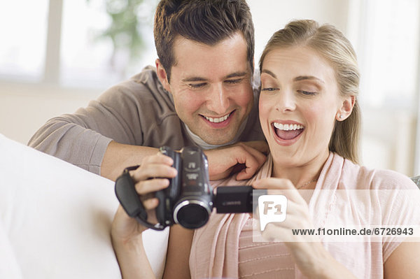 Couple looking at picture on video camera