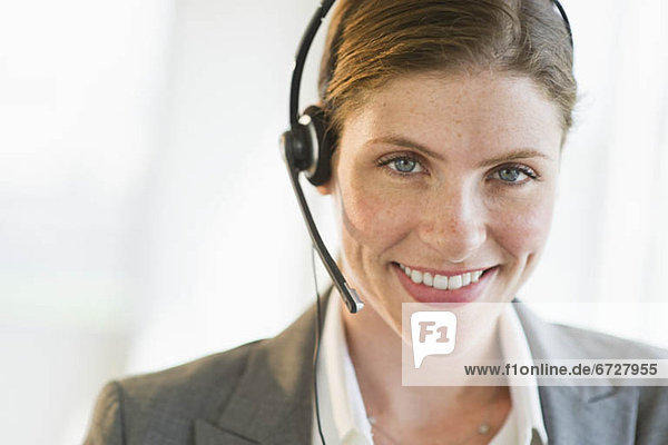 Portrait of smiling woman with headset