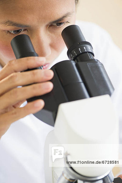 USA  New Jersey  Jersey City  Female scientist using microscope