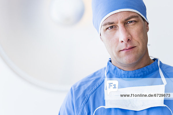 Portrait of male surgeon in operating room
