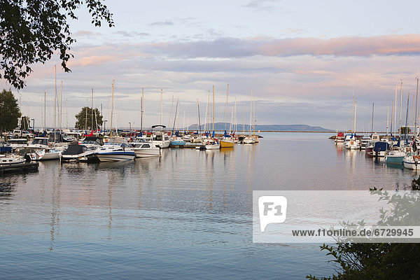 'Boats In The Harbour At Sunset