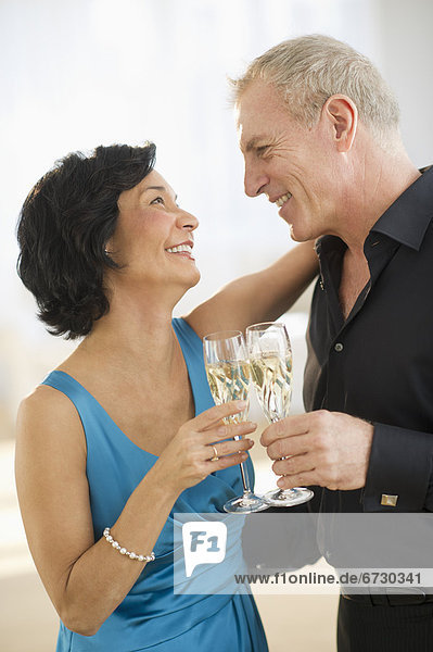 Happy mature couple with flutes