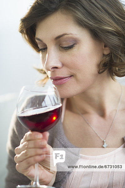 USA  New Jersey  Jersey City  portrait of woman smelling red wine