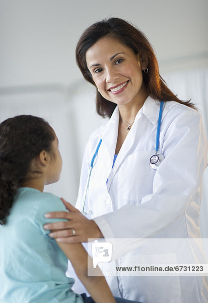 USA  New Jersey  Jersey City  female pediatrician examining girl (6-7) in doctor's office