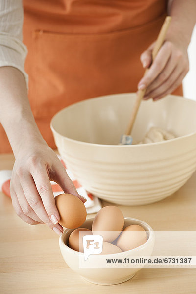 Woman preparing dough in bowl