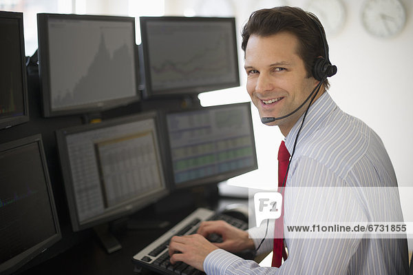 Portrait of financial worker analyzing data displayed on computer screen