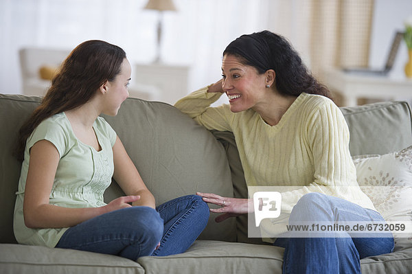 Mother talking to teenage daughter (14-15)