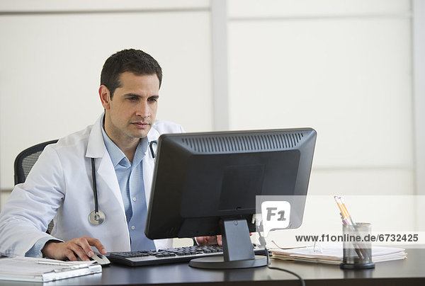 Doctor using computer in office