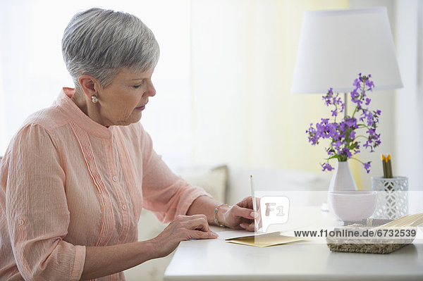 Senior woman writing letter