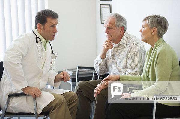 Senior couple talking to doctor