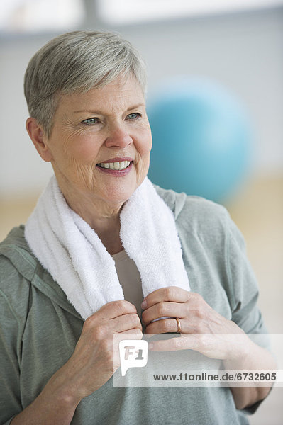 Smiling senior woman in gym
