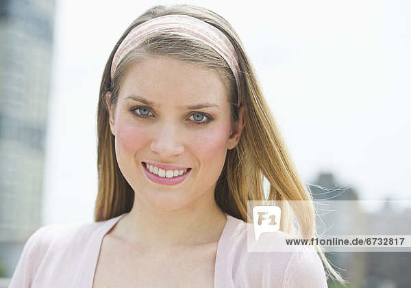 Portrait of young woman smiling outdoors