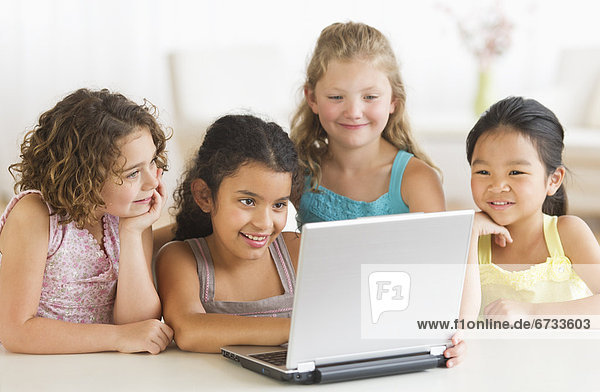 Four girls (6-9) using laptop