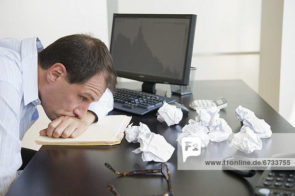 Businessman with face down on desk