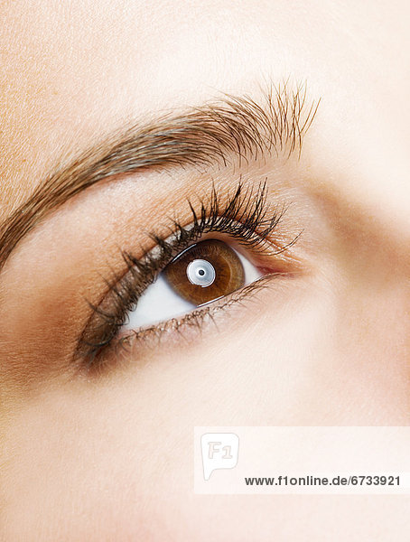 Studio shot of young woman  close-up of eye