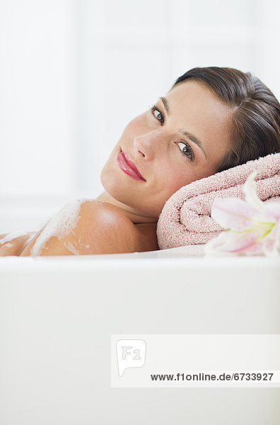 Young woman taking bath