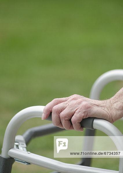Senior walking with walker  close-up of hands
