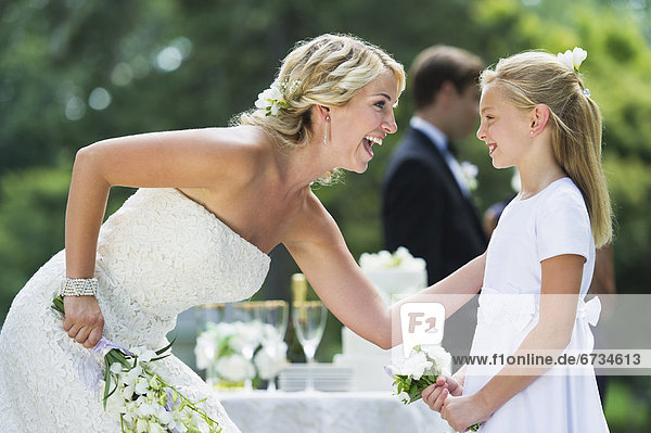 Bride with flower girl (10-11) at wedding reception