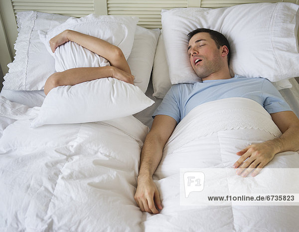 Couple in bed  man snoring