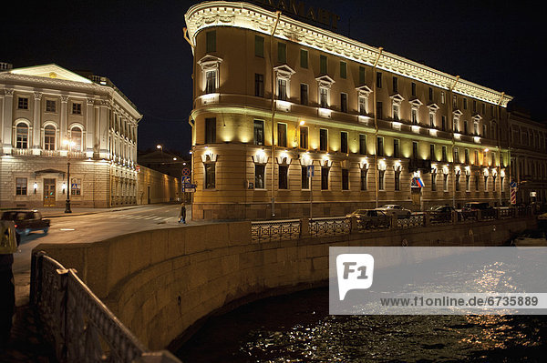 'A building illuminated at night on the edge of moyka river