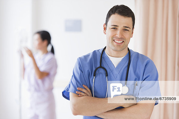 Portrait of doctor  nurse in background