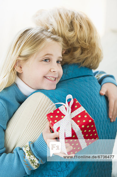 Geschenk  umarmen  halten  Enkeltochter  Großmutter  5-9 Jahre  5 bis 9 Jahre