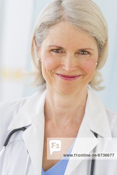 Portrait of senior female doctor smiling