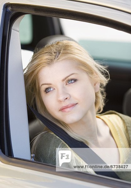 Woman sitting in passenger side of car