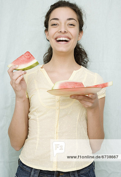 Woman eating watermelon slices
