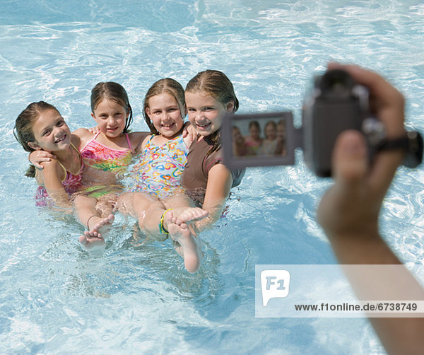 Girls being videotaped in swimming pool