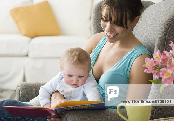 Mother and baby looking at book
