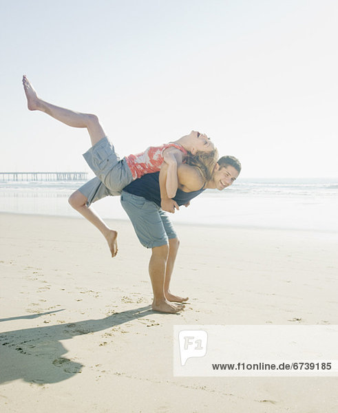Couple playing around on beach