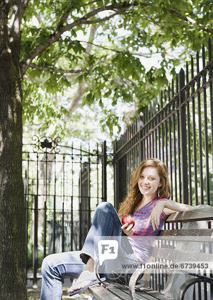 Woman relaxing on park bench