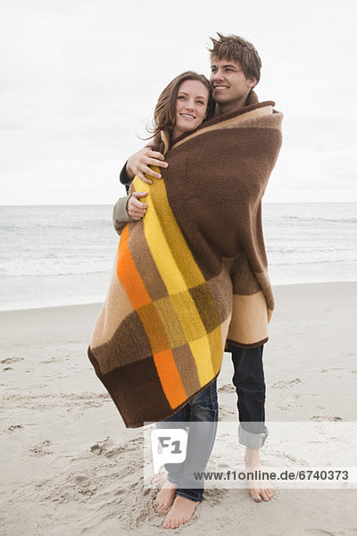 Couple wrapped in blanket
