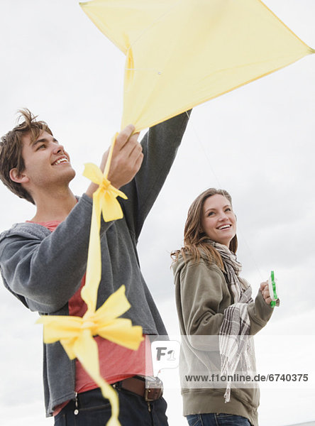 Couple flying kite