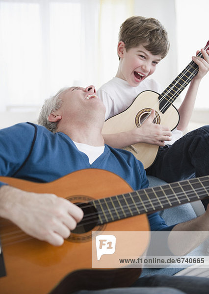 Father and son playing guitars