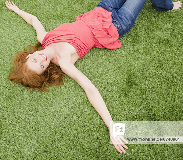 Beautiful woman relaxing on grass