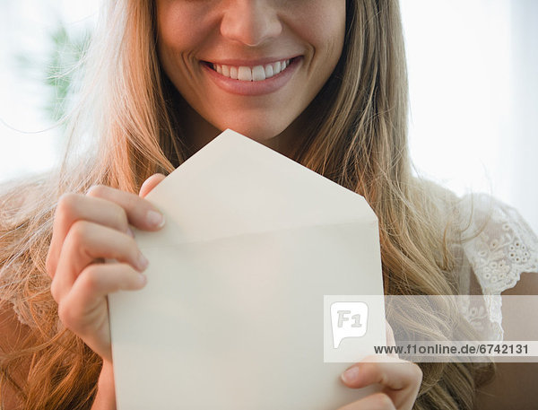 Portrait of blonde woman holding envelope