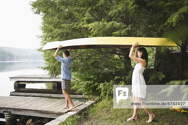 Roaring Brook Lake  Couple carrying boat by lake