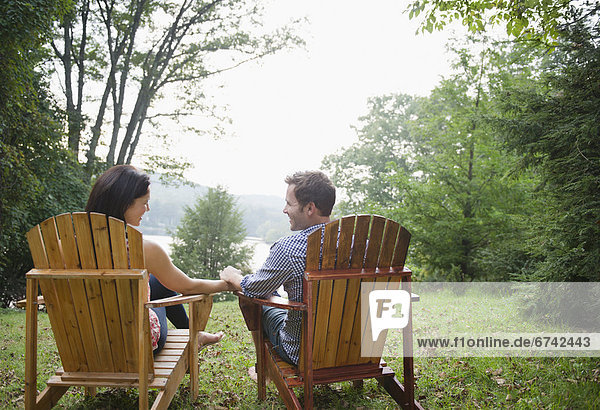 USA  New York  Putnam Valley  Roaring Brook Lake  Couple relaxing by lake