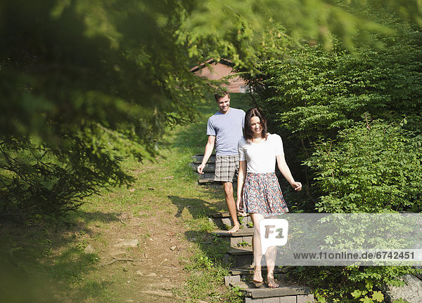USA  New York  Putnam Valley  Roaring Brook Lake  Couple walking down steps among trees