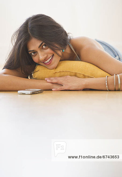 USA  New Jersey  Jersey City  Portrait of attractive young woman laying on floor