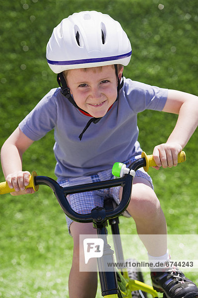 Boy (4-5) riding bike
