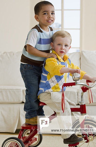 Two children on a tricycle
