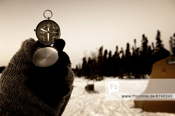 Hand Holding Compass  Northwest Territories near Blachford lake.