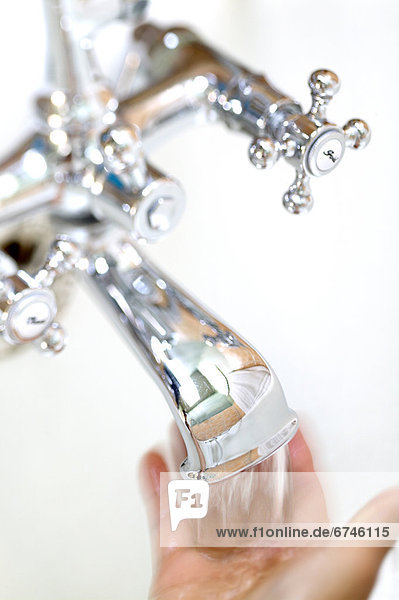 Hand Under Running Faucet