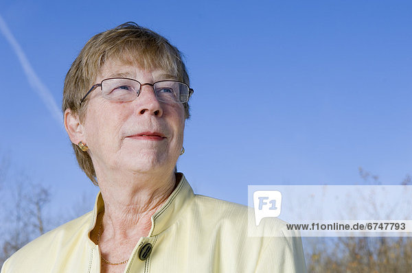 Portrait of Senior Woman against Blue Sky